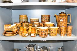 A Hornsea Bronte pattern dinner service, decorated with geometric patterns on a brown glaze