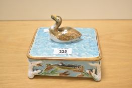 A late 19th century George Jones Majolica lidded sardine box having duck handle and decorated with