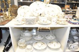A Royal Doulton 'The Coppice' pattern dinner service decorated with foliage and pheasants on a cream