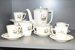 A Royal Copenhagen tea service decorated with foliage and gilt edging on an ice white ground, makers