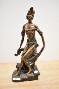 An Art Deco patinated metal sculpture of a female dancer on a three step base, H34cm