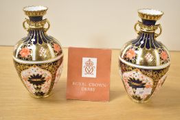 A pair of Royal Crown Derby Imari twin handle vases of baluster form, makers mark to base, date code