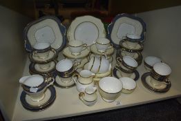 A part Wedgwood tea service having gilt edges on a cream and white ground, makers mark to base,