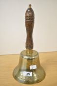 A large polished brass hand bell with mahogany handle, h30