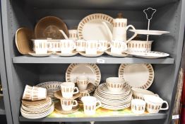 A large vintage dinner service decorated with geometrical patterns on a cream glaze ground, to