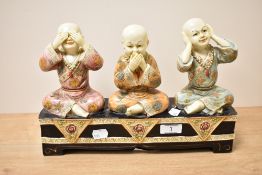 A ceramic Buddhist sculpture of three wise monks, to include hear no evil, see no evil and speak