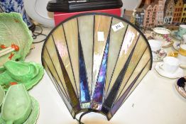 A reproduction Tiffany style art-deco wall sconce in pearl and iridescent black.