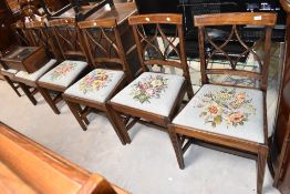 A set of six early 20th Century Regency revival dining chairs having drop in woolwork seats