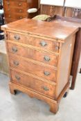 A reproduction Regency style desk chest of four drawers, with fold over top and supports