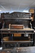 A Victorian carved oak three tier buffet/sideboard, width approx. 151cm