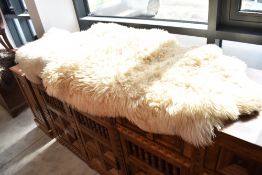 Three assorted sheepskin rugs, including Ikea