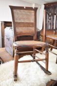 A Victorian cane seated rocking chair