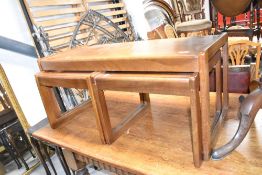 A vintage teak nesting coffee table set, width approx. 96cm