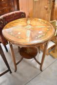 An Edwardian occasional table having circular top and undertier, with painted foliate decoration,