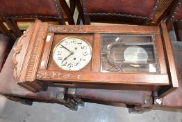 An early 20th Century oak cased wall clock