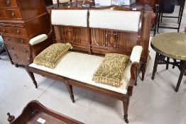 An Edwardian mahogany and inlaid salon settee
