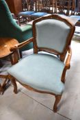 A reproduction upholstered carver chair