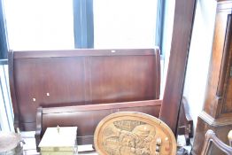 A modern mahogany sleigh bed