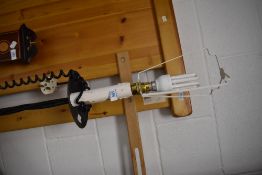 A wrought iron standard lamp having faux candle fitting