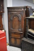 An early 20th Century oak double corner cupboard in the period style, height approx. 167cm