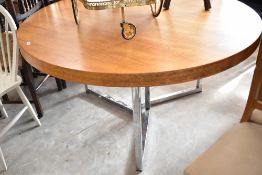 A vintage Leigh and Chinn/Gordon Russell or similar design circular dining table having chrome legs,