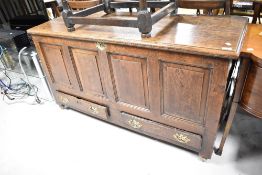 A period oak kist having four panels and two drawers to base