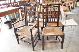 A traditional harlequin set of six (five plus one) spindle back chairs , having rush/seagrass seats