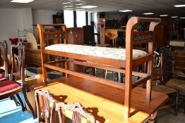 A late 19th or early 20th Century mahogany framed window seat having later upholstery