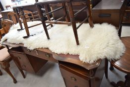 A sheepskin rug, approx 6 foot in length
