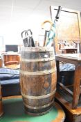 An antique barrel stick stand and contents