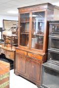 A reproduction Regency bookcase with double cupboard under, width approx. 99cm