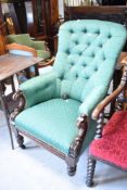 A Victorian easy chair having scroll frame and later button back upholstery
