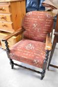 A late 19th or early 20th Century oak armchair having twist frame and later script upholstery