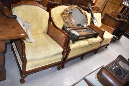 A reproduction hardwood lounge suite having bergere style cane work back and sides