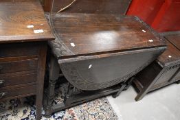 A 19th Century gateleg dining table having carved edge, width approx. 88cm