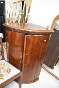An early 20th Century mahogany bow fronted corner wall cupboard, height approx. 100cm
