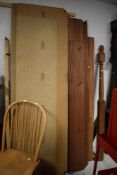 An untreated wooden four poster bed, possibly mahogany , dismantled