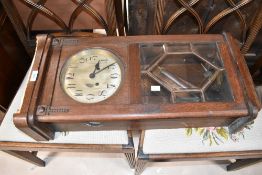 An early 20th Century oak cased wall clock having silver dial with arabic numerals