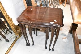 A period style nest of three occasional tables having inlaid decoration