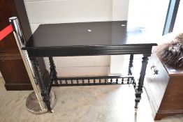 A Victorian ebonised side table having turned legs and spindle supports, approx. 91 x 45cm