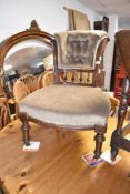A Victorian mahogany framed nursing chair having later dralon upholstery, with button back and