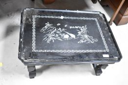 A laquerwork occasional table having mother of pearl chinoiserie bird and foliate decoration,