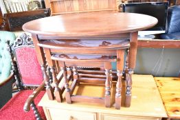 A vintage nest of three oak oval tables, width approx. 82cm