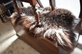 A vintage sheepskin rug, brown and white colourings