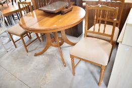 A modern pine extending dining table and set of four chairs