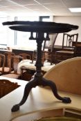A 19th Century mahogany occasional table having birdcage support, and triple splay legs with ball