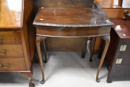 An early 20th Century mahogany fold over card table, width approx. 69cm