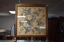 An early 20th Century oak framed tapestry firescreen