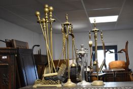 Four assorted brass and chrome companion stands