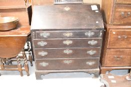 A Georgian mahogany bureau, with historical worm to end panels